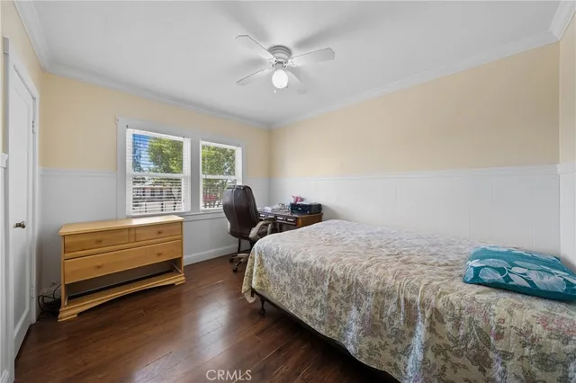 a bedroom with a bed and cabinet