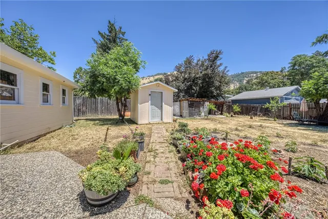 a backyard of a house with table and chairs