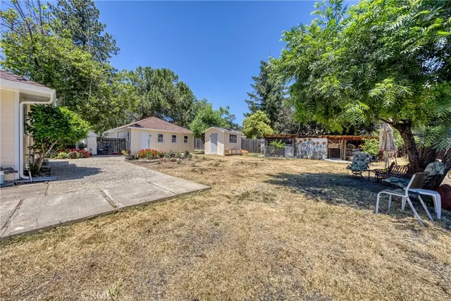 a swimming pool with outdoor seating and yard