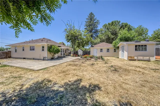 a view of a house with backyard and sitting area