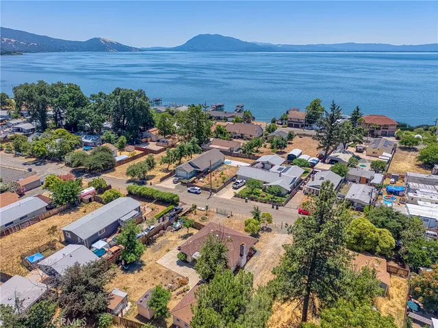 an aerial view of a house with a yard and a fountain