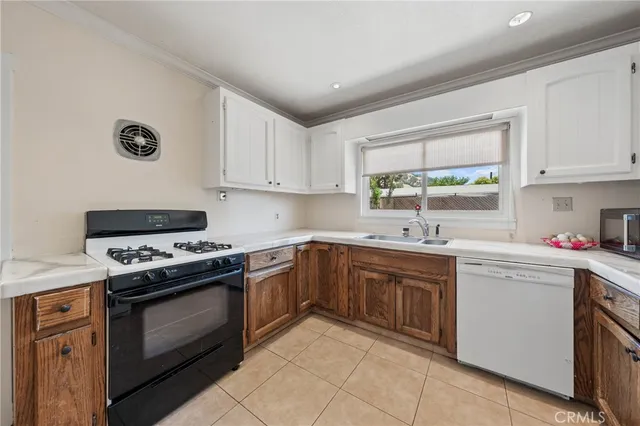 a kitchen with a stove sink and cabinets