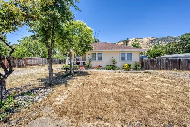 a view of a house with backyard and sitting area