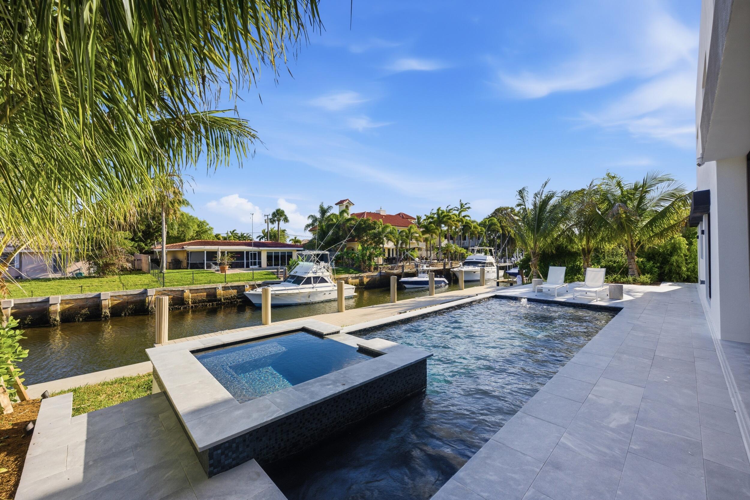 2360 Northeast 49th Street Lighthouse Point, FL 33064 - Photo 53 of 66 a view of a swimming pool with lounge chairs