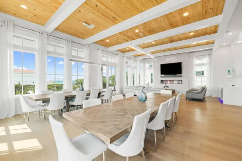 a view of a roof deck with table and chairs and wooden floor