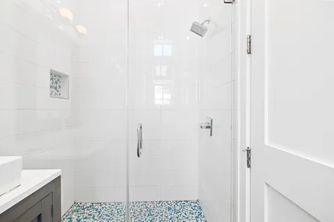 a spacious bedroom with a bed and a chandelier