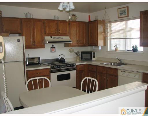 625 B Deal Road Monroe Township, NJ 08831 - Photo 2 of 10 a kitchen with stainless steel appliances granite countertop a stove a sink dishwasher a refrigerator and a microwave