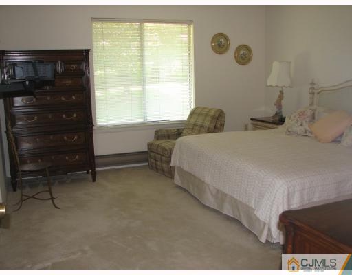 625 B Deal Road Monroe Township, NJ 08831 - Photo 4 of 10 a bedroom with a bed and a window