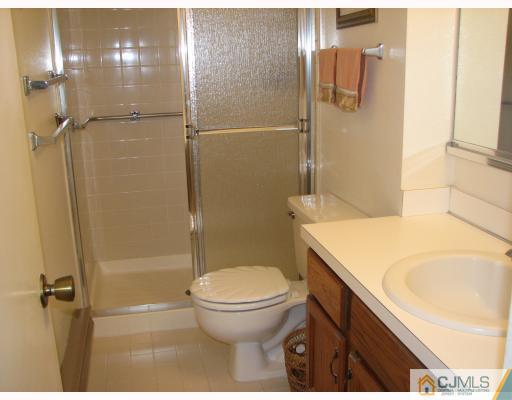 625 B Deal Road Monroe Township, NJ 08831 - Photo 5 of 10 a bathroom with a granite countertop sink toilet and shower