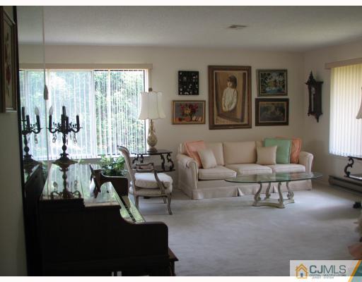 625 B Deal Road Monroe Township, NJ 08831 - Photo 6 of 10 a living room with furniture and a large window