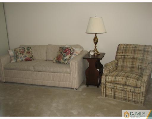 625 B Deal Road Monroe Township, NJ 08831 - Photo 7 of 10 a living room with furniture and a lamp