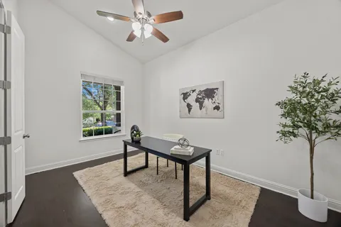 a view of a livingroom with furniture and a potted plant