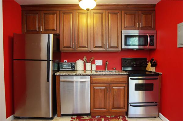 479 Beacon Street, Unit 11 Boston, MA 02115 - Photo 3 of 8 a kitchen with stainless steel appliances granite countertop a refrigerator stove and sink