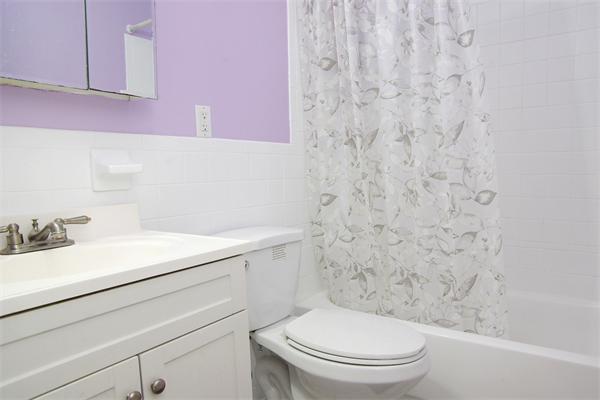 479 Beacon Street, Unit 11 Boston, MA 02115 - Photo 5 of 8 a bathroom with a sink a toilet and vanity