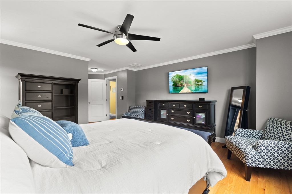 6 Jacoby Way Seekonk, MA 02771 - Photo 19 of 42 a bedroom with a bed a dresser and a chandelier