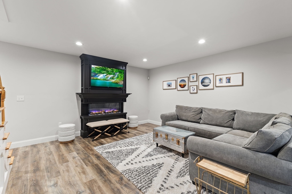 6 Jacoby Way Seekonk, MA 02771 - Photo 31 of 42 a living room with furniture a flat screen tv and a fireplace