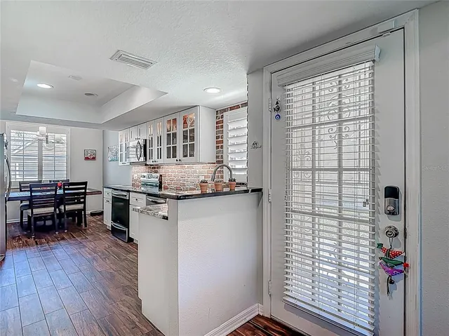 a kitchen with stainless steel appliances granite countertop a stove and a sink