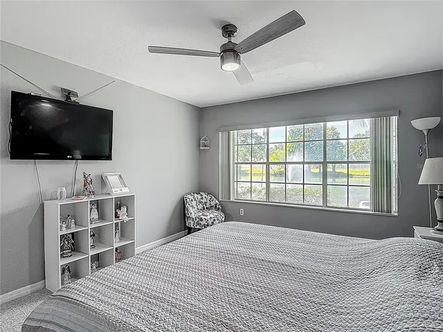 a bedroom with a bed and wall painting