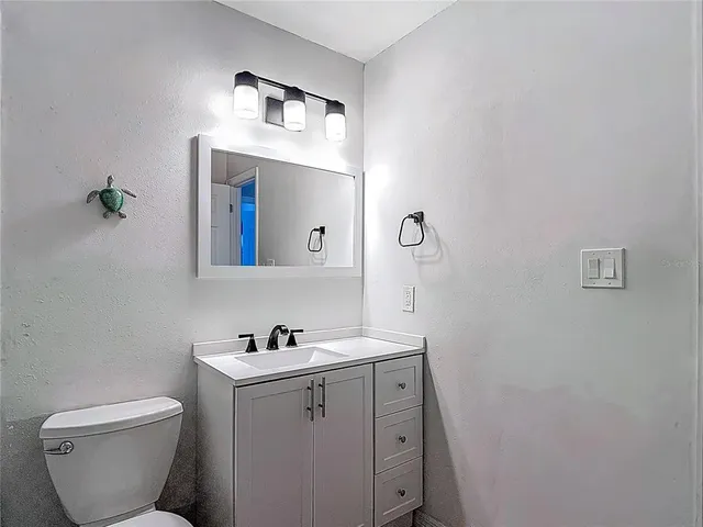 an aerial view of a house with garden space and trees all around