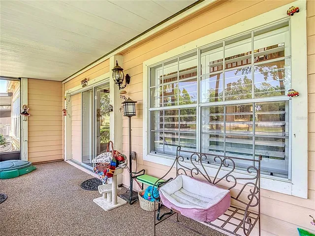 a view of a big house with a big yard plants and large trees