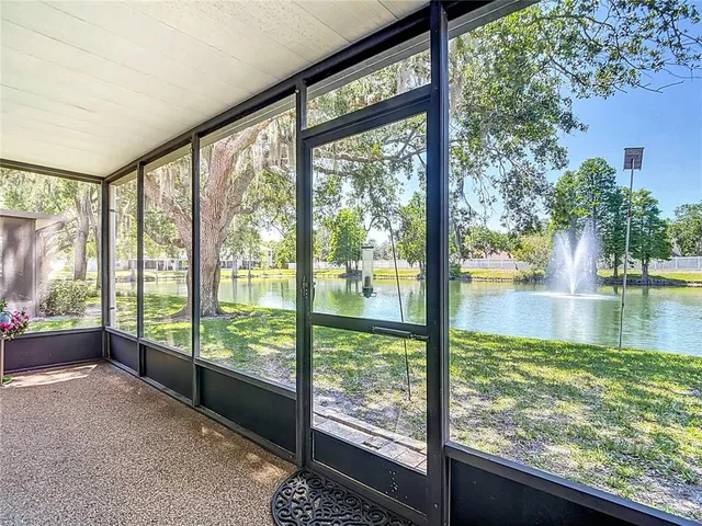 an aerial view of residential house with outdoor space and trees all around
