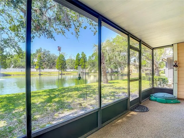 an aerial view of residential house with outdoor space and trees all around