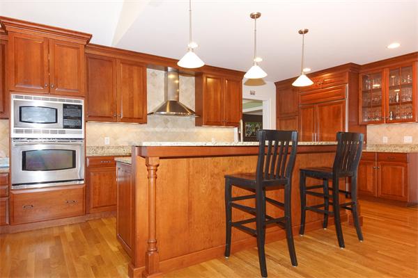 75 Deerfield Road Needham, MA 02492 - Photo 9 of 27 a kitchen with stainless steel appliances granite countertop a kitchen island a stove and a wooden cabinets