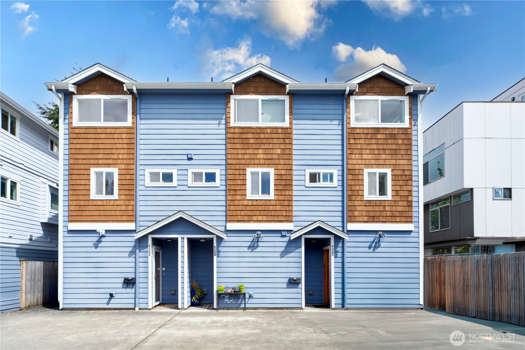 6348 34th Avenue Southwest, Unit C Seattle, WA 98126 - Photo 1 of 24 a front view of a house with a yard and garage