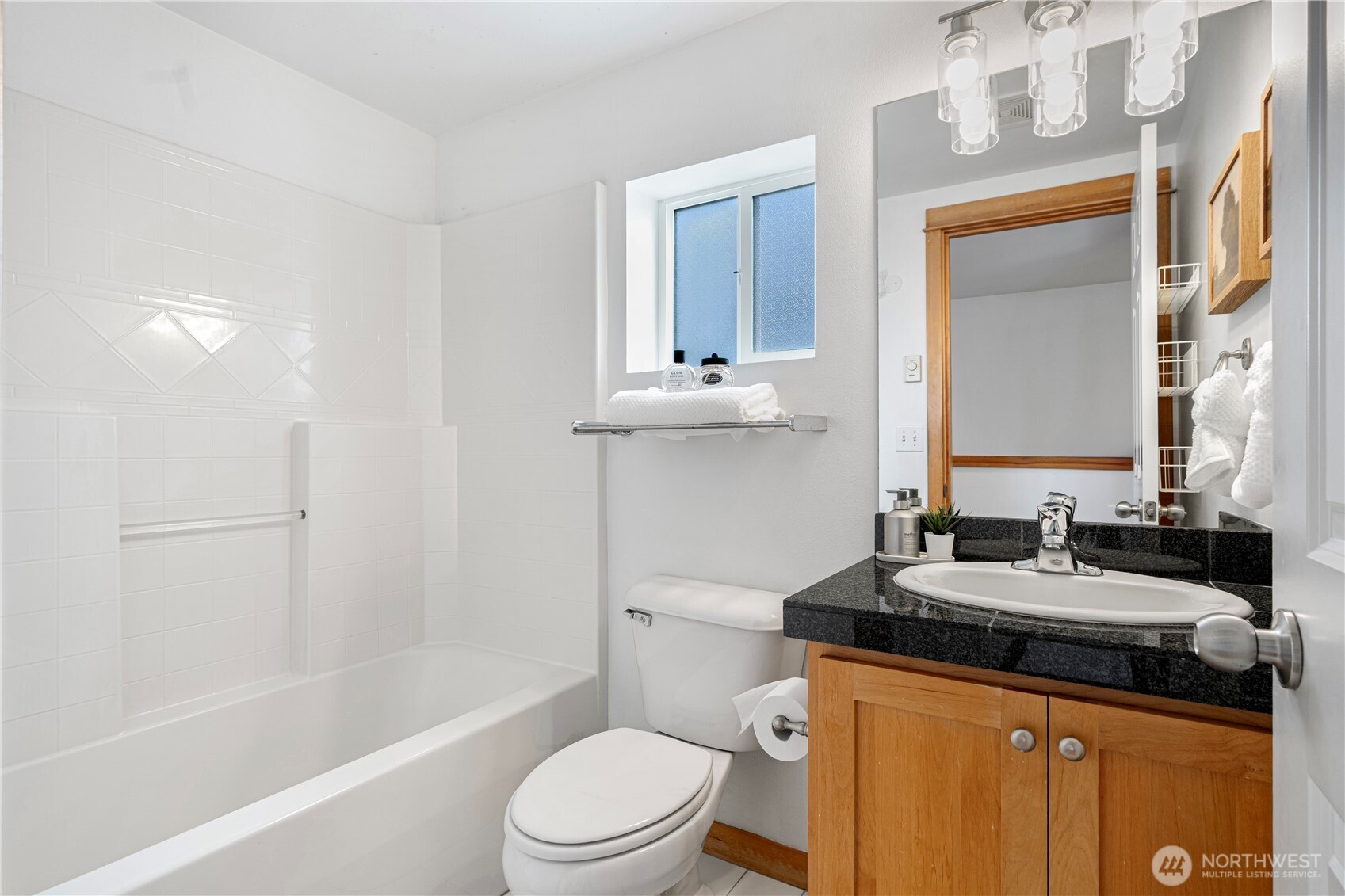 6348 34th Avenue Southwest, Unit C Seattle, WA 98126 - Photo 20 of 24 a bathroom with a granite countertop sink toilet and mirror