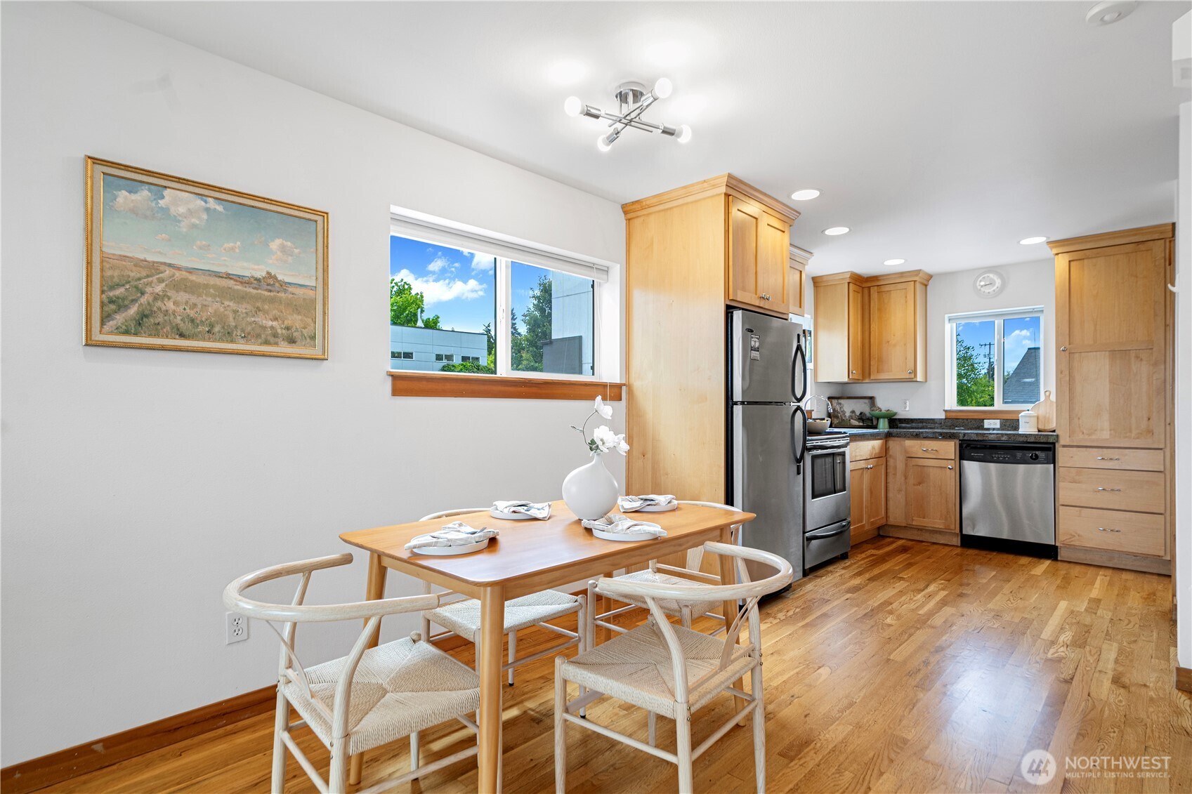6348 34th Avenue Southwest, Unit C Seattle, WA 98126 - Photo 7 of 24 a kitchen with stainless steel appliances wooden floor and a refrigerator