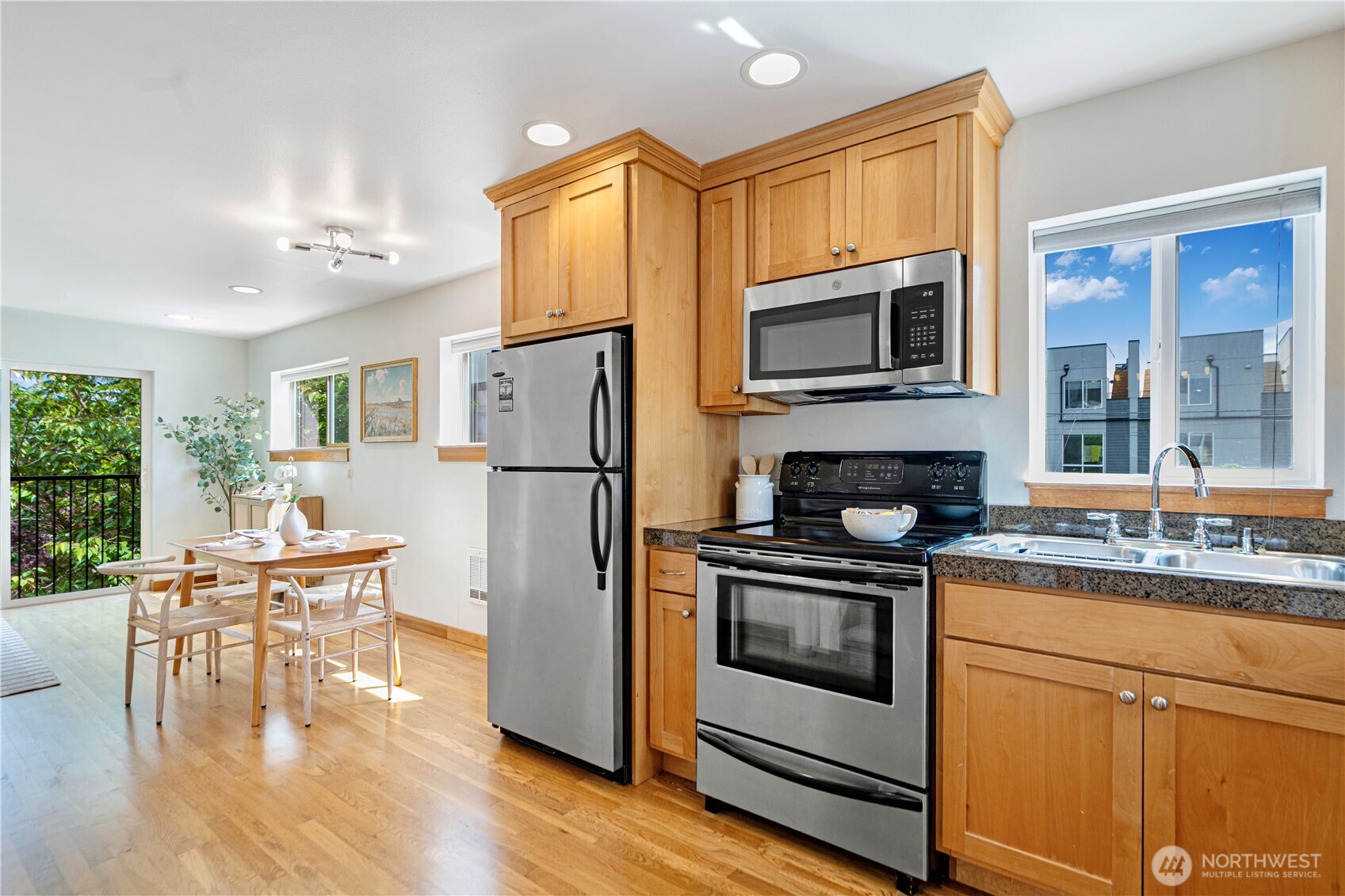 6348 34th Avenue Southwest, Unit C Seattle, WA 98126 - Photo 9 of 24 a kitchen with a stove a refrigerator and a stove top oven