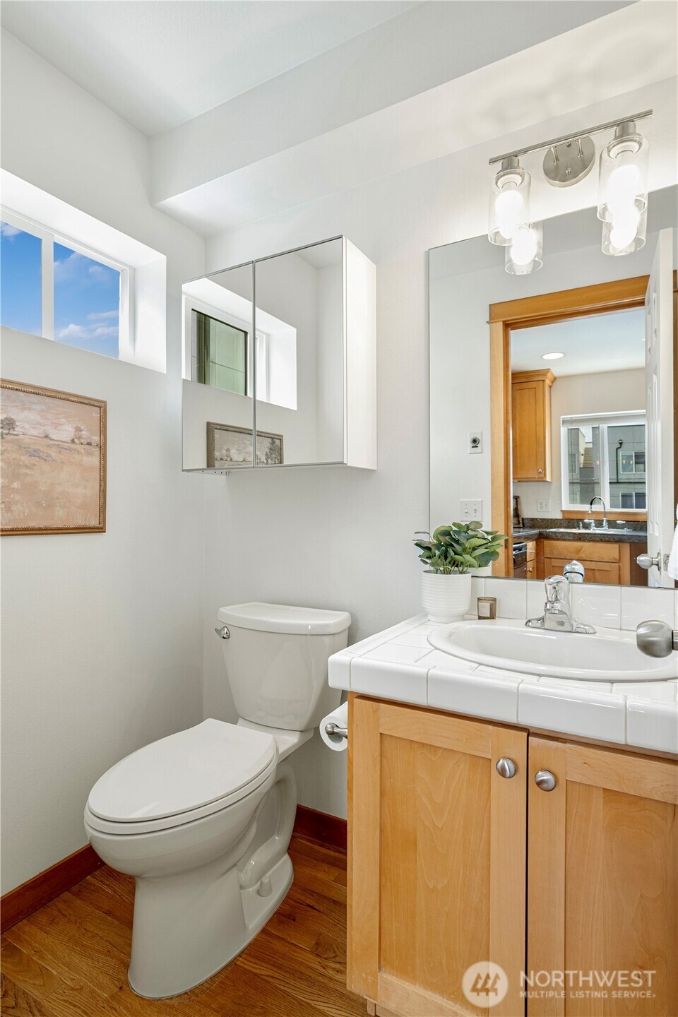 6348 34th Avenue Southwest, Unit C Seattle, WA 98126 - Photo 10 of 24 a bathroom with a sink a toilet and mirror