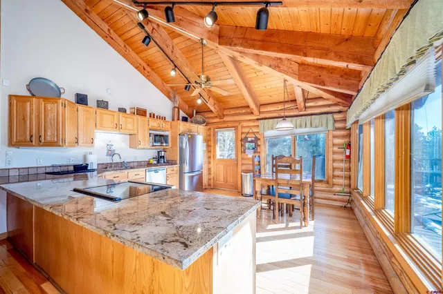 a kitchen with stainless steel appliances granite countertop a sink and counter space