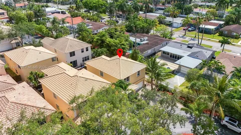 an aerial view of residential houses with outdoor space and street view