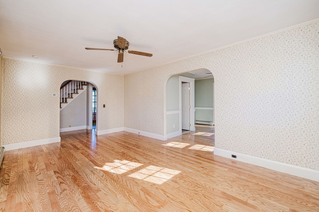 31 South Main Street Bellingham, MA 02019 - Photo 12 of 41 a view of a livingroom with wooden floor and a ceiling fan