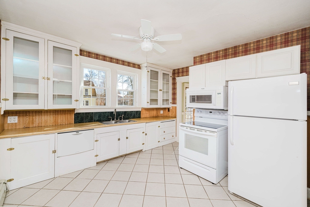 31 South Main Street Bellingham, MA 02019 - Photo 16 of 41 a kitchen with white cabinets a refrigerator and a sink