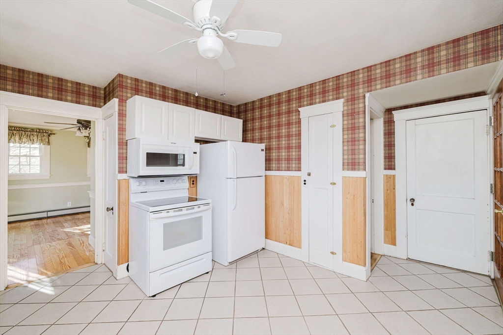 31 South Main Street Bellingham, MA 02019 - Photo 19 of 41 a kitchen with white cabinets and refrigerator