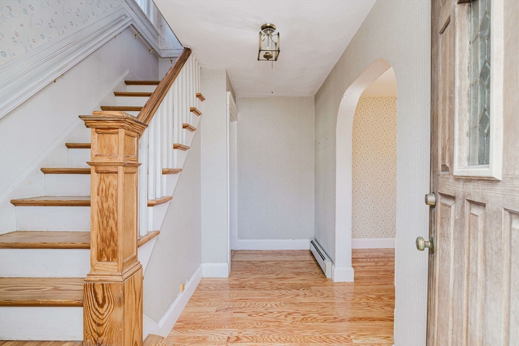 31 South Main Street Bellingham, MA 02019 - Photo 5 of 41 a view of a hallway with wooden floor and entryway