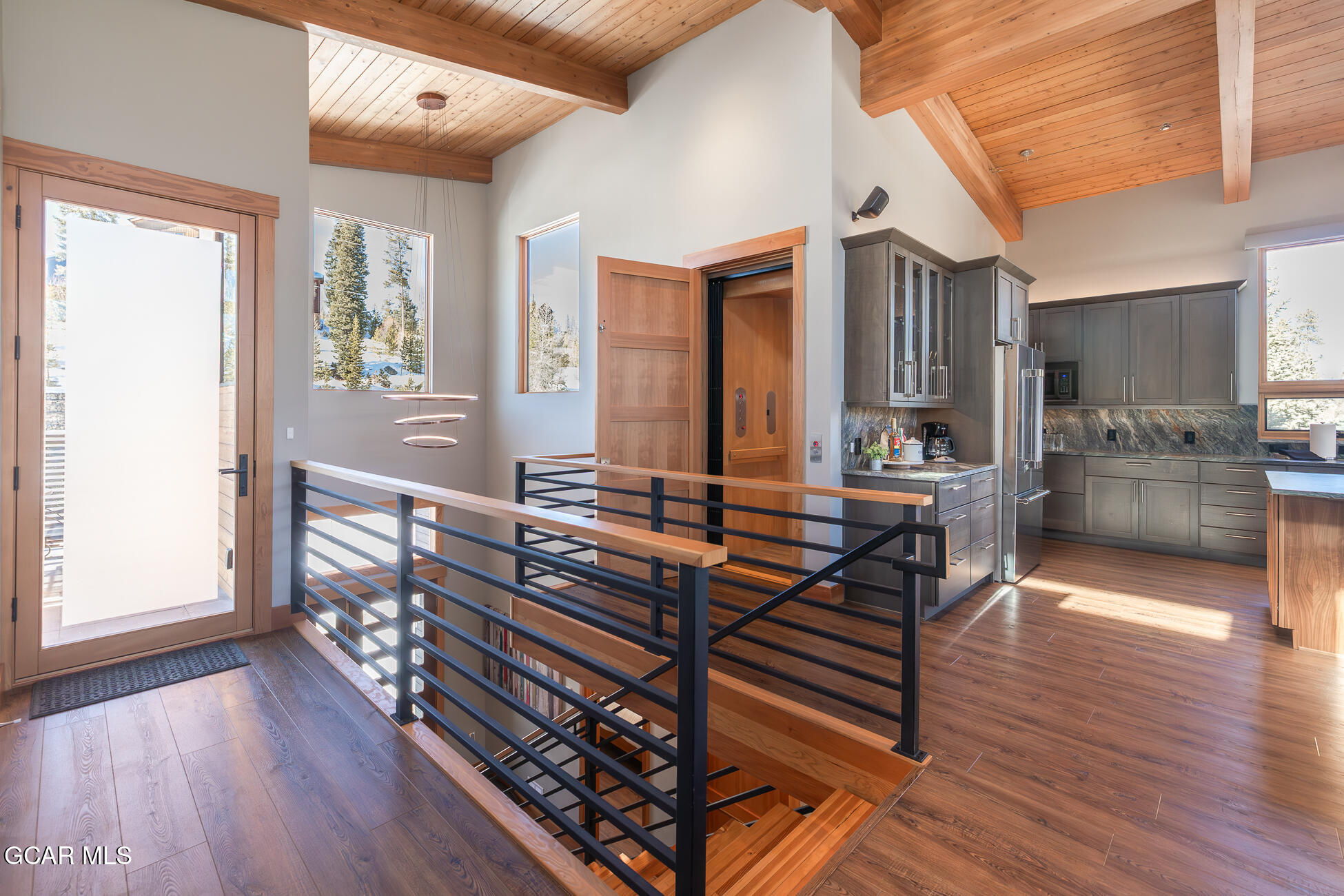 684 Vasquez Road Winter Park, CO 80482 - Photo 39 of 45 a room with lots of wooden furniture and large windows