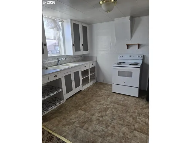 a kitchen with stainless steel appliances a stove sink and cabinets