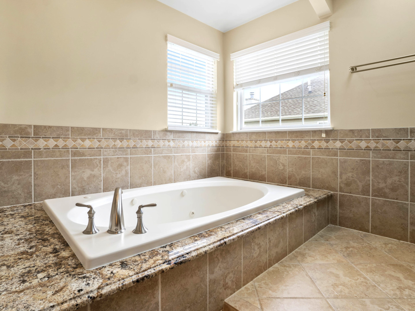18714 West Lazy Acre Road Lake Villa, IL 60046 - Photo 15 of 36 a bath tub sitting in a bathroom next to a window
