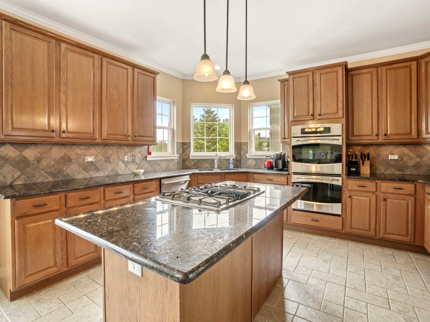 18714 West Lazy Acre Road Lake Villa, IL 60046 - Photo 6 of 36 a kitchen with stainless steel appliances granite countertop a stove top oven a sink dishwasher and microwave with wooden floor