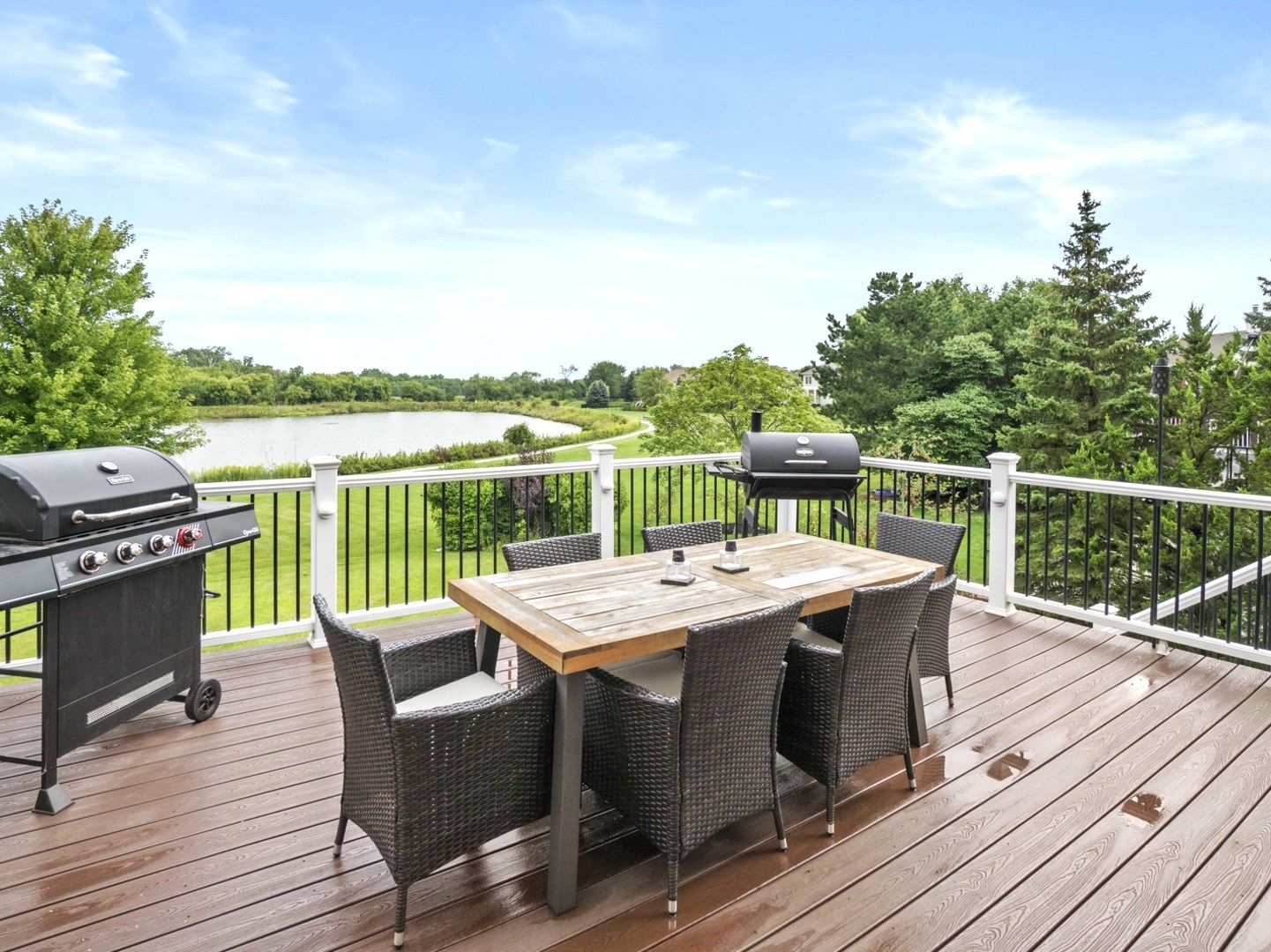 18714 West Lazy Acre Road Lake Villa, IL 60046 - Photo 8 of 36 a view of a deck with table and chairs a barbeque with wooden floor and fence