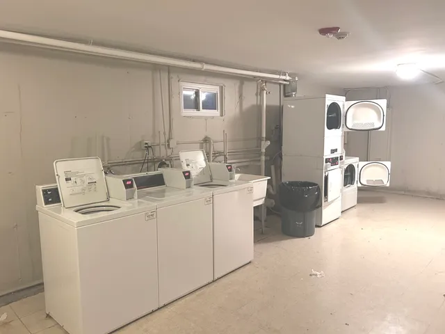 a room with a washing machine and cabinets