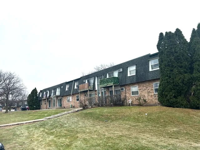 a view of a house with a yard and plants