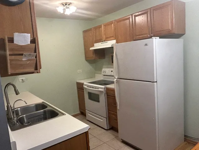 a kitchen with a refrigerator sink and stove