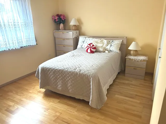a bedroom with a bed and a potted plant