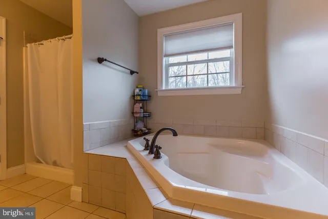 a bathroom with a bathtub and shower