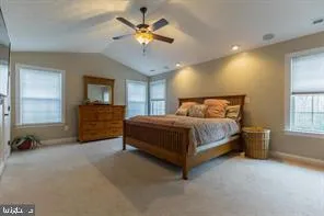 a bedroom with a bed chandelier and a window