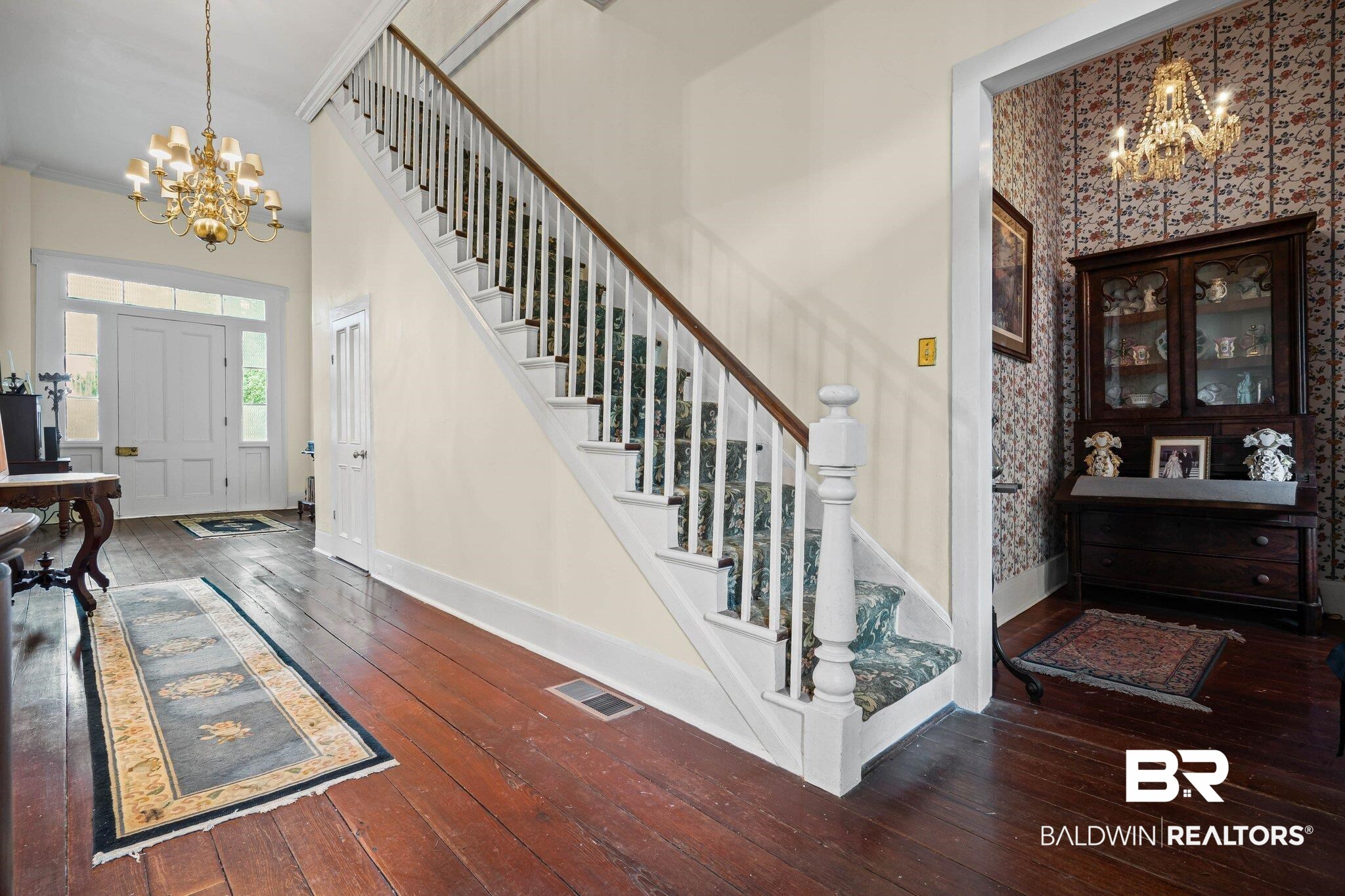 23561 Main Street Fairhope, AL 36532 - Photo 5 of 45 Entryway with a chandelier and dark wood-style floors